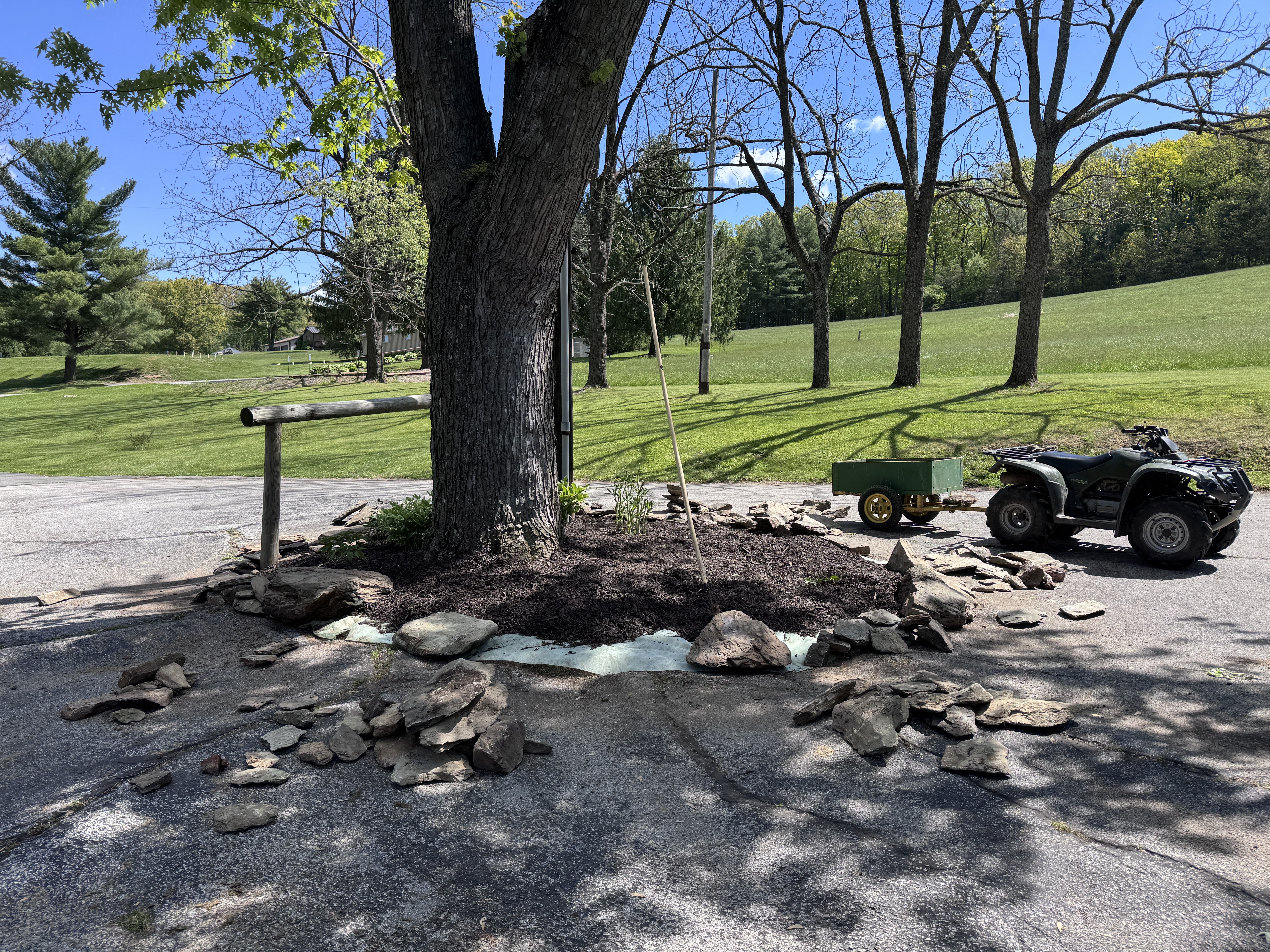 Wide shot of the island with ATV and cart, new stones sorted on the driveway